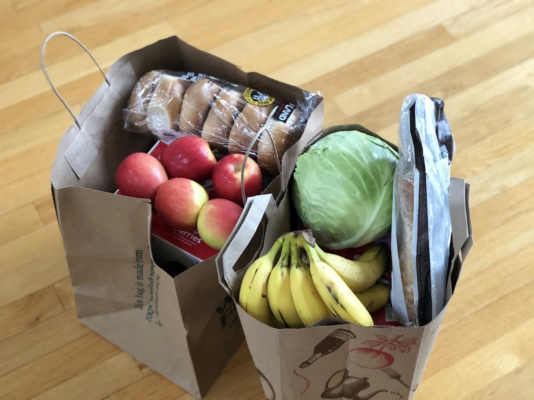 A box of fresh fruit and vegetables from a grocery run