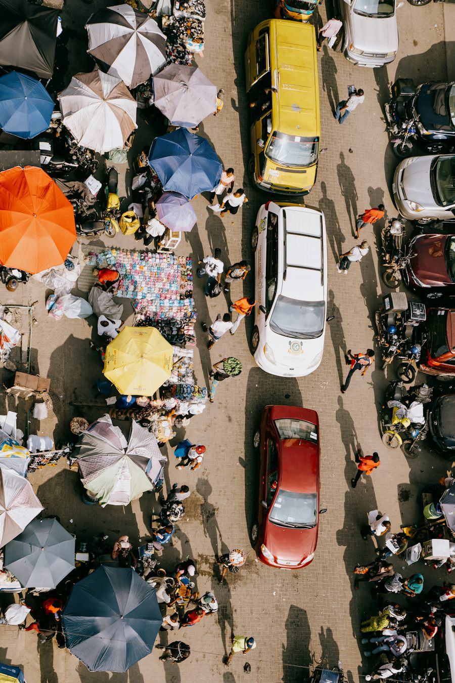 A busy street market of stalls and traders, the kind of vendor Sendy buys from